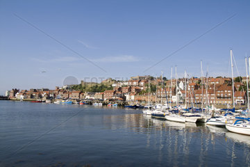 Harbor with boast in the Harbour of beautiful tourist town of Whitby England