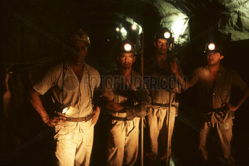 Brazil. Miners wearing hard hats with lights.