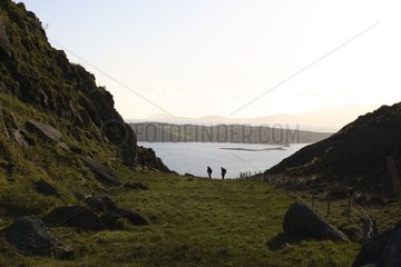 Hikers in coastal landscape Ireland