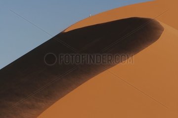 Tourist on a sand dune Namib-Naukluft Namibia