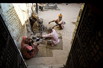 Inhabitants sitting in the courtyard of a house Uttar Pradesh India