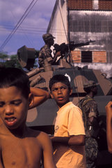 Rio de Janeiro  Brazil. Conflict between Brazilian Army x Drug traffic. Children in risk  social problems  military person combating urban violence. Fear  insecurity  use of weapons  cannon.