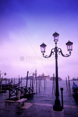 Beautiful graphic line up of group of gondolas ready for tourists in romantic Venice Italy