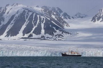 Cruise in front of large glacier in of fiord Svalbard
