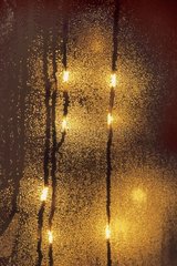 Light of Christmas through a window with mist