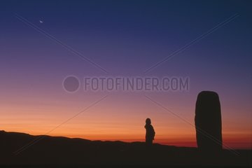 Man and Moon rising close to a menhir Lozere Mount