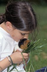 Young girl making a kiss with a guinea-pig