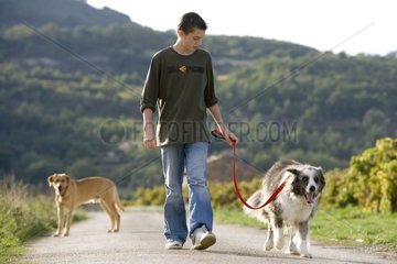 Young boy walking an old dog in the countryside France