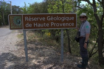 Ranger near a sign in Haute Provence geological NR France