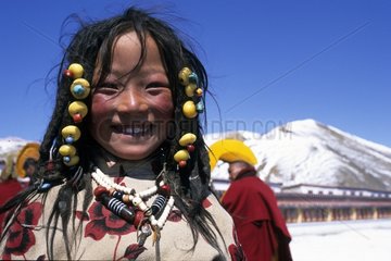 Young Tibetan girl with a traditional ornament Serxu
