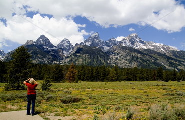 Senior retired tourist enjoying the beautiful Grand Tetons mountain range near Jackson Wyoming in National Park USA