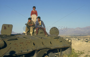 near Kabul  children play on russian tank.