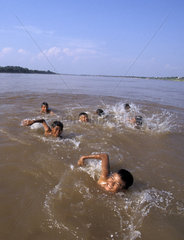 Boys swimming in the Mekong river
