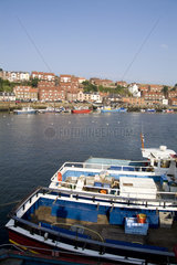 Harbor with fishing boats in the Harbour of beautiful tourist town of Whitby England