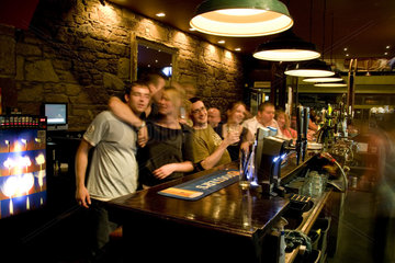 Happy young people at the 21 degree North Bar on Queens Gate Street in the quaint town of Inverness Scotland in the Highlands home of the Loch Ness Monster