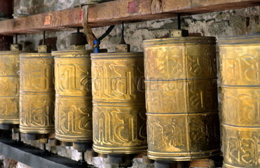 Prayer wheels brass at the wonderful Potala Palace the home of the Dalai Lama in capital city of Lhasa Tibet China