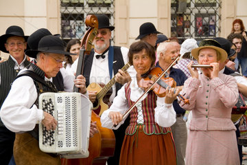 Close up of local people in traditional costume in dancing band in famous Old Town of tourist city of Prague in Czech Republic