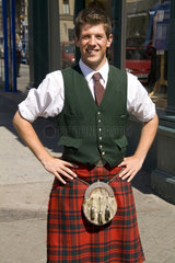 Young attractive local man in traditional kilt in capital of Edinburgh Scotland