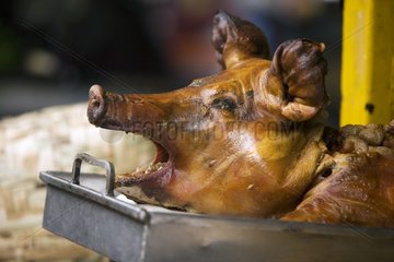 Roasted Pig's head on a market stall Otavalo Ecuador