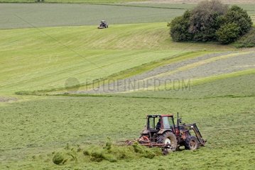 Tractor turning over the second crop of hay Doubs France