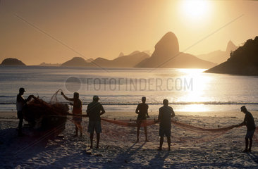 Fishermen in Niterói  twin city of Rio de Janeiro  Brazil. In the background view od Sugar Loaf and Corcovado hill ( Christ statue ).