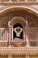 Jodhpur at Fort Mehrangarh in Rajasthan India man in window of Fort Palace in costume