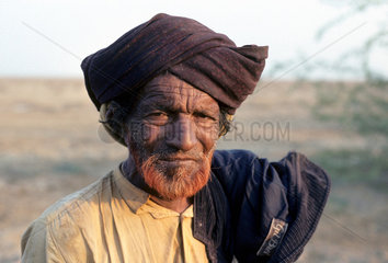 INDIA : Gujarat. The Kutch. Cattle herder in the desert north of Bhuj.