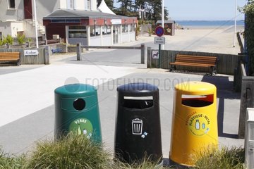 Containers for recyclables next to the beach