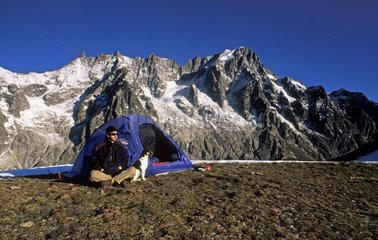Hiker and his tent on the Mont de la Saxe Italy