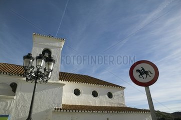 Street lamp and panel in front of a church La Axarquia