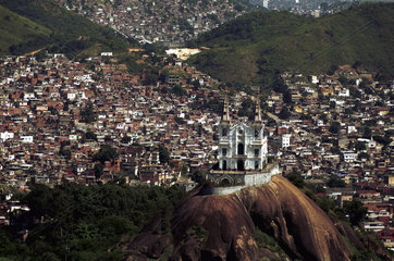 Vila Cruzeiro slum in Rio de Janeiro  Brazil. Shantytown where Globo TV reporter Tim Lopes was murdered by drug dealers. Igrega da Penha ( Penha church ) in the foreground.