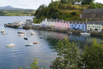 Beautiful port and sailboats with reflections in small tourist village of Portree in Isle of Skye Western Highlands Scotland