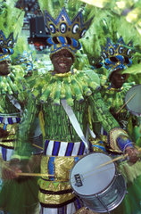 Culture. Samba Schools Parade  Carnival  Rio de Janeiro  Brazil. Imperatriz Leopoldinense 2002. Bateria  black man playing drum  afro-brazilian percussion instruments  green costumes  festival  energy  musical instruments.