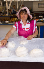 Woman selling cheese at indoor market in city center of Lviv Ukraine