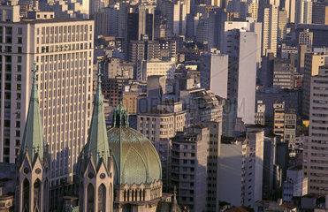 Downtown Sao Paulo  Brazil. Catholic church roof and commercial buildings. architecture  business  religion  Catholicism  differences  urban landscape  cosmopolitan  crowded  Sao Paolo