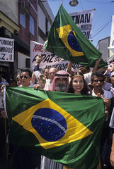 Demonstration in downtown Rio de Janeiro  Brazil. Arab community in Rio and local population demonstrates against race prejudice against the Muslim community in Brazil after September 11  2001. Confraternization  Brazil flag.