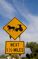 Old fashioned horse and buggy sign on road in Upstate New York near Rochester for safety