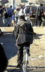 Kabul  local militia on a bicycle