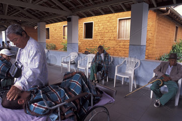 Casa do Caminho ( Path-way House ). City: Araxss; State: Minas Gerais; Brazil. Geriatric Hospital takes in chronically paralyzed patients or those totally dependent on bedside care. Handicapped patient takes confort to another one . Tenderness.