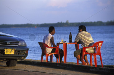 Paramaribo  drinking a beer at the shore of the Surinam river