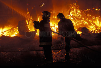 Valencia  firemen controlling the fire at the burning of the ninos the Las Fallas festival