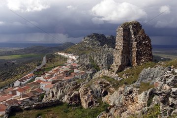 Ruin overlooking a village under the clouds Spain