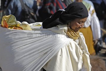 Woman carrynig a bag on Otavalo market Ecuador