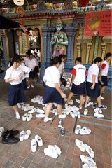 Junge MÃ¤dchen entfernen ihre Schuhe vor einem Tempel