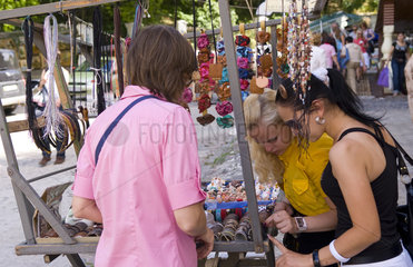 Shoppers looking at jewelry ands at market in Andres Street at Klovskiy Spusk downtown in Old Town Kiev Ukraine