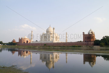 World famous Taj Mahal temple burial site at sunset from Yamuna River with reflection in town of Agra India