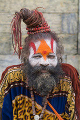 Kathmandu Nepal religious man who is a character painted in costume near river at famous Pashupatinath holi Hindu place on Bagmati River