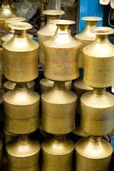 Stack of beautiful brass milk jugs or pots in Durbar Square in center of village of Kathmandu Nepal
