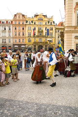 Polka dancing by local people in traditional costume with dancing band in famous Old Town of tourist city of Prague in Czech Republic