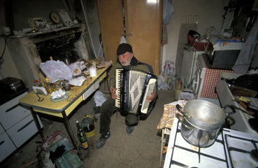 Calcata  Paolino (72) plays his melancholy songs in his neglected house